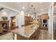 Spacious kitchen featuring an expansive granite island and stainless steel appliances at 3132 E Harwell Rd, Phoenix, AZ 85042