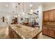 Bright, open kitchen with granite countertops and modern lighting at 3132 E Harwell Rd, Phoenix, AZ 85042