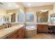 Bright bathroom with dual sinks, jacuzzi, and separate vanity area at 3132 E Harwell Rd, Phoenix, AZ 85042