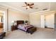 Neutral main bedroom boasts bedside table, ensuite access, and large walk-in closet at 3132 E Harwell Rd, Phoenix, AZ 85042