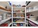 Walk-in pantry with floor-to-ceiling shelving and plenty of room for storage at 3132 E Harwell Rd, Phoenix, AZ 85042