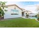 A view of the backyard lawn and pool at 32815 N Slate Creek Dr, San Tan Valley, AZ 85143