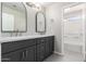 Bathroom with dual vanity, decorative mirrors, and tiled shower/tub combo at 32815 N Slate Creek Dr, San Tan Valley, AZ 85143