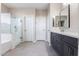 Modern bathroom featuring a glass-enclosed shower and dark vanity with double sinks at 32815 N Slate Creek Dr, San Tan Valley, AZ 85143