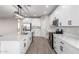 Well-lit kitchen showcasing a large island with quartz counters, stainless appliances, and sleek white cabinets at 32815 N Slate Creek Dr, San Tan Valley, AZ 85143