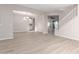 Open-concept living area showing staircase, dining, and kitchen areas with continuous wood-look tile floors at 32815 N Slate Creek Dr, San Tan Valley, AZ 85143