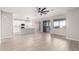 Open living space with an island kitchen, light-colored walls, and continuous wood-look tile flooring at 32815 N Slate Creek Dr, San Tan Valley, AZ 85143