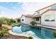 A view of the pool behind the home, framed by lush landscaping and the home's exterior at 32815 N Slate Creek Dr, San Tan Valley, AZ 85143