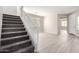 Carpeted staircase leading to the upper level, with a bright entryway and a spacious room visible at 32815 N Slate Creek Dr, San Tan Valley, AZ 85143