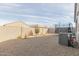 Spacious backyard featuring gravel landscaping, block fencing and a trampoline for outdoor activities at 35374 W San Sisto Ave, Maricopa, AZ 85138