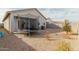 View of the backyard showcasing a trampoline, gravel landscaping and block fencing for privacy at 35374 W San Sisto Ave, Maricopa, AZ 85138