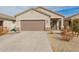 Charming single-story home with a two-car garage, neutral stucco, and low-maintenance desert landscaping at 35374 W San Sisto Ave, Maricopa, AZ 85138