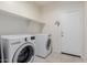 Laundry room featuring a washer, a dryer, and shelving at 35374 W San Sisto Ave, Maricopa, AZ 85138