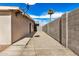 Gravel backyard showcasing privacy wall and palm tree against a clear blue sky at 3611 W Hazelwood St, Phoenix, AZ 85019