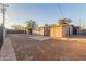 Wide backyard view showcases mature landscaping, block fence and covered patio at 3611 W Hazelwood St, Phoenix, AZ 85019