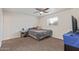 Bright bedroom with ceiling fan, carpet flooring and a window for natural light at 3611 W Hazelwood St, Phoenix, AZ 85019