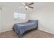 Bright bedroom with carpet flooring, ceiling fan and large window at 3611 W Hazelwood St, Phoenix, AZ 85019