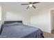 Bedroom featuring carpet floors, ceiling fan and window for natural light at 3611 W Hazelwood St, Phoenix, AZ 85019