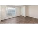 This vacant bedroom features hard floors, a window, and a closet at 3611 W Hazelwood St, Phoenix, AZ 85019