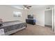 Bedroom featuring carpet floors, with window and ceiling fan, complemented by a television set at 3611 W Hazelwood St, Phoenix, AZ 85019