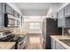 Stainless steel appliances and mosaic backsplash in the kitchen area at 3611 W Hazelwood St, Phoenix, AZ 85019