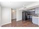 Open kitchen and dining area featuring wood floors and blue cabinets with stainless steel refrigerator at 3611 W Hazelwood St, Phoenix, AZ 85019