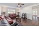 Inviting living room with wood-look floors, modern ceiling fan, and comfortable furnishings at 3611 W Hazelwood St, Phoenix, AZ 85019