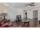 Spacious living room with ceiling fan and lots of natural light from the large window at 3611 W Hazelwood St, Phoenix, AZ 85019