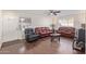 Inviting living room featuring wood-look floors, light walls, and contemporary furniture at 3611 W Hazelwood St, Phoenix, AZ 85019