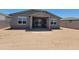 The backyard features a covered patio, desert landscaping, and sliding glass doors leading inside at 3850 N Camden Dr, Florence, AZ 85132