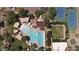 Aerial view of a community pool, tennis courts and community area surrounded by lush landscaping and walking paths at 3912 E Williams Dr, Phoenix, AZ 85050