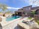 Resort-style backyard with sparkling pool, lounge chairs and lush landscaping at 3912 E Williams Dr, Phoenix, AZ 85050