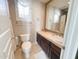 Cozy bathroom features a vanity with a decorative backsplash and patterned wallpaper at 3912 E Williams Dr, Phoenix, AZ 85050