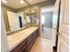 Bathroom with a double sink vanity, tile counters, and mirror at 3912 E Williams Dr, Phoenix, AZ 85050