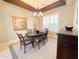 Elegant dining room with coffered ceiling, chandelier, and a large buffet cabinet at 3912 E Williams Dr, Phoenix, AZ 85050