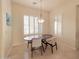 Cozy dining area with modern chandelier and shuttered windows at 3912 E Williams Dr, Phoenix, AZ 85050