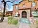 Charming home features a stone archway with decorative iron gate and well-manicured landscaping at 3912 E Williams Dr, Phoenix, AZ 85050