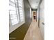 Hallway with beautiful tiled floors, white doors, and window with plantation shutters at 3912 E Williams Dr, Phoenix, AZ 85050