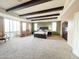 Main bedroom featuring beamed ceilings, walls of windows and spacious layout at 3912 E Williams Dr, Phoenix, AZ 85050