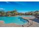 Resort-style pool featuring tanning decks, lounge chairs, and umbrellas offers a luxurious outdoor living space at 3912 E Williams Dr, Phoenix, AZ 85050