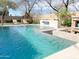 Beautiful backyard pool and spa area with waterfall feature and lounge chairs at 3912 E Williams Dr, Phoenix, AZ 85050