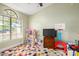 A colorful bedroom with a window, toys and a basket ball hoop at 3957 E Adobe St, Mesa, AZ 85205