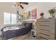 A simple bedroom with a dresser, bed and pictures on the wall at 3957 E Adobe St, Mesa, AZ 85205