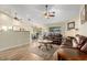 Cozy living room featuring hardwood floors, ceiling fans, and a decorative fireplace at 3957 E Adobe St, Mesa, AZ 85205