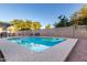 Serene pool area with clear water, surrounded by a paved deck, lush greenery, and a relaxing ambiance at 3957 E Adobe St, Mesa, AZ 85205