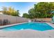 Backyard swimming pool with a safety fence, chairs, and a relaxing outdoor setting for Gathering enjoyment at 3957 E Adobe St, Mesa, AZ 85205