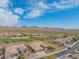 A beautiful aerial shot of the property surrounded by desert landscape and mountains, with golf course views at 40607 N Candlewyck Ln, Phoenix, AZ 85086