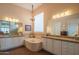 Luxurious bathroom with a bathtub, chandelier, double sink vanity, and wood look tile flooring at 40607 N Candlewyck Ln, Phoenix, AZ 85086