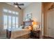 Inviting bedroom with ceiling fan and plantation shutters overlooking a serene view at 40607 N Candlewyck Ln, Phoenix, AZ 85086