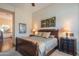 Comfortable bedroom with a wooden bed frame, matching bedside tables, and a view to the bath at 40607 N Candlewyck Ln, Phoenix, AZ 85086